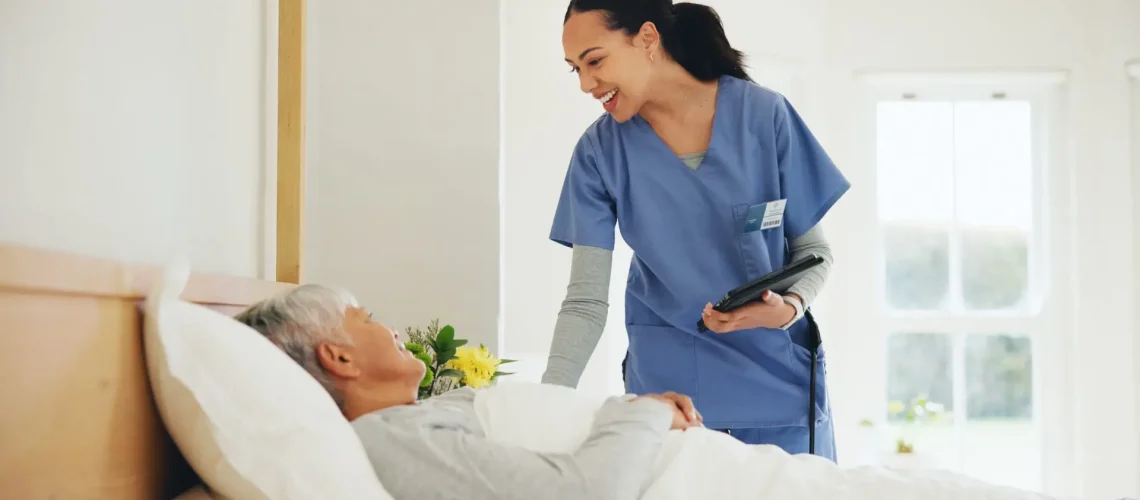 happy-woman-nurse-and-tablet-with-patient-in-bed-2023-12-01-06-25-19-utc-scaled-1